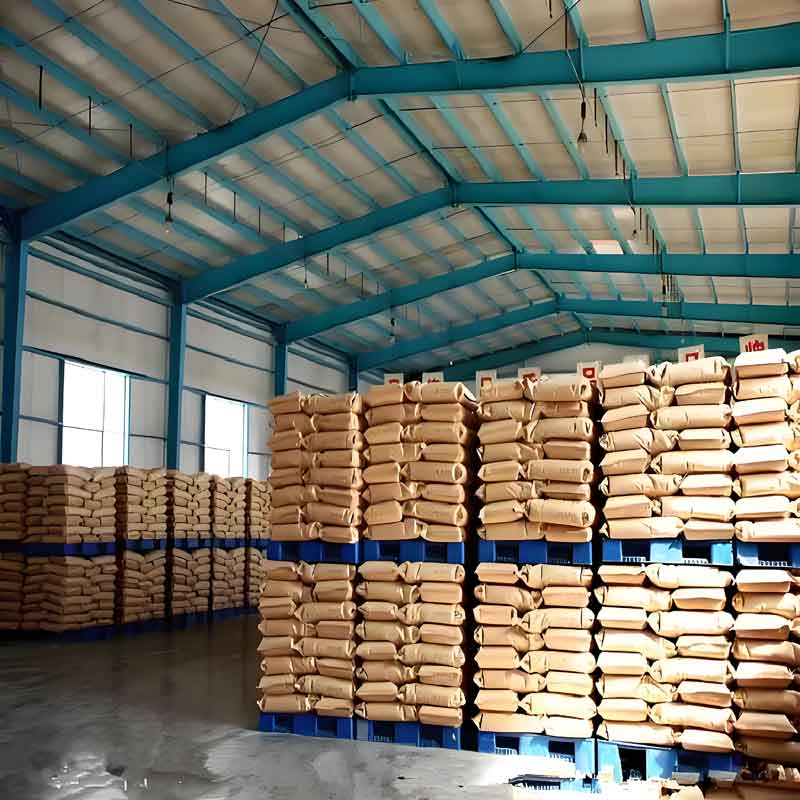 Warehouse shelves neatly stocked with labeled bags of polyacrylamide for water treatment.